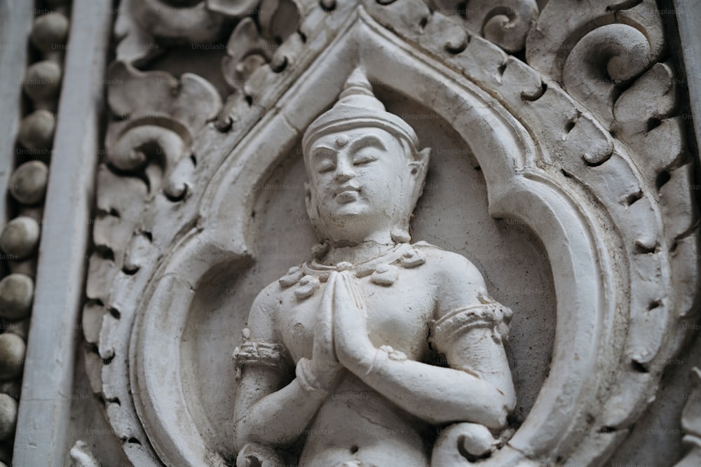 a statue of a man holding a bird on top of a building