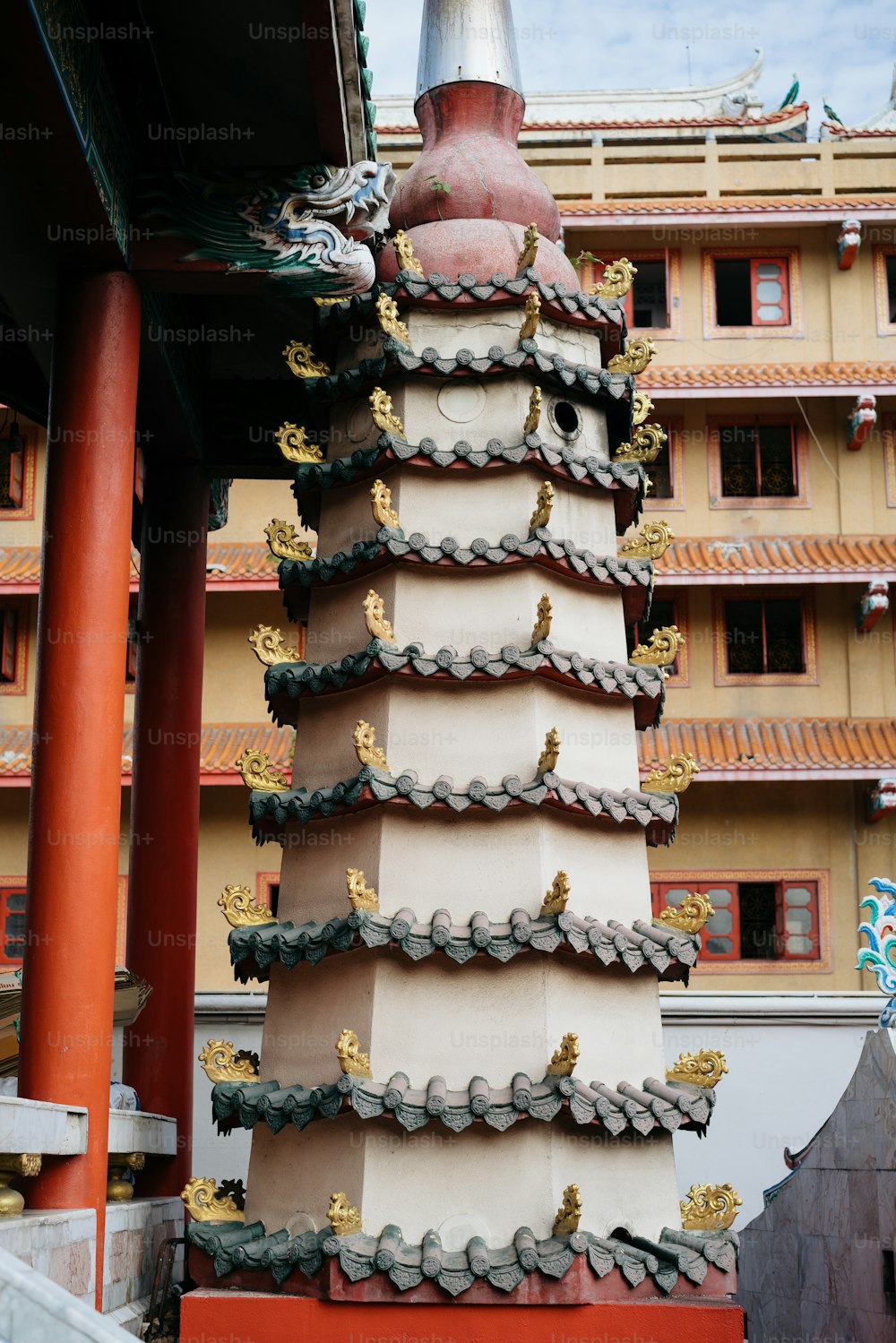 a tall building with a red and white roof