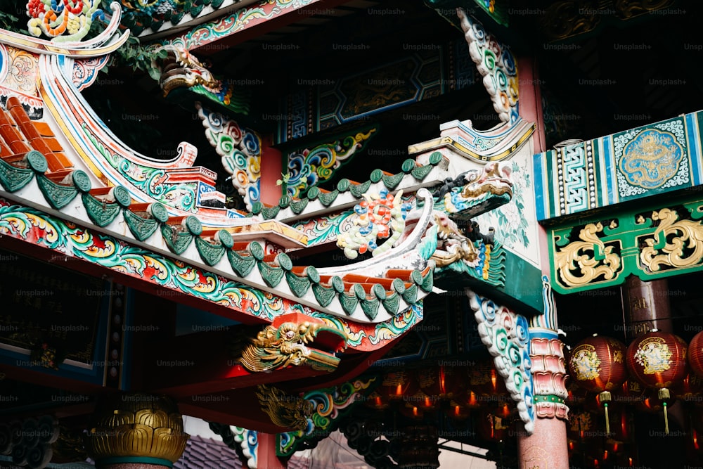 a colorful dragon sculpture on the side of a building