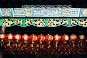 a group of red lanterns hanging from a ceiling