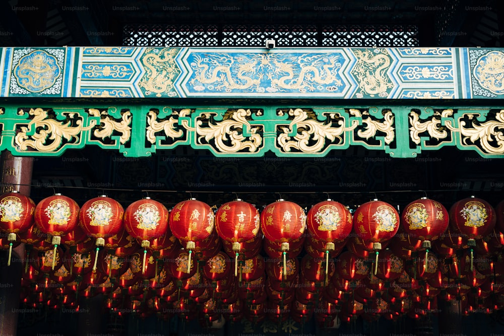 a group of red lanterns hanging from a ceiling