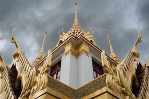 a gold and white building with a sky background