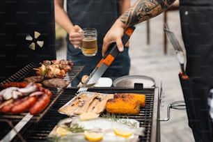 a man holding a knife cutting meat on a grill