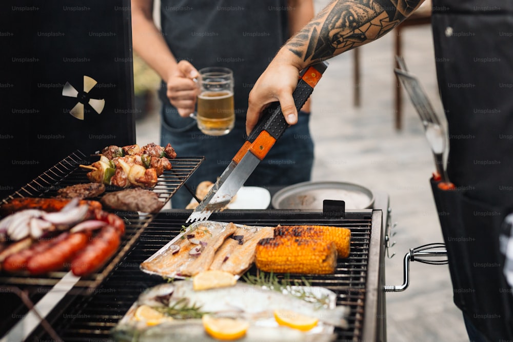 a man holding a knife cutting meat on a grill