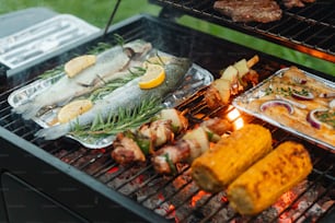 a bbq grill with various foods cooking on it