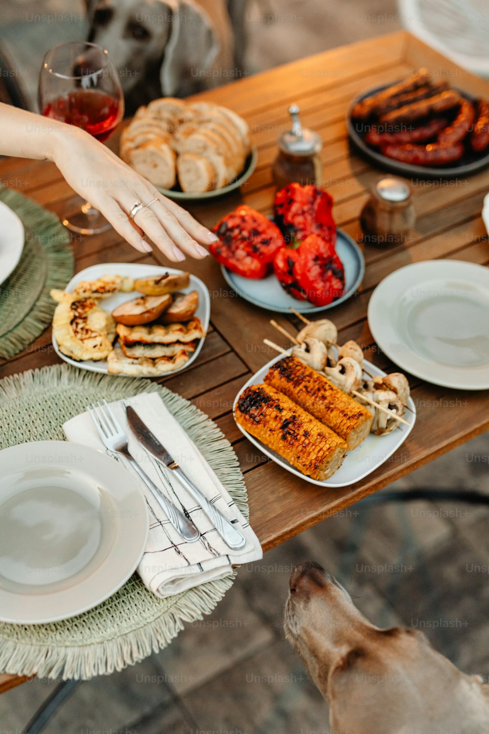 a person reaching for food on a table