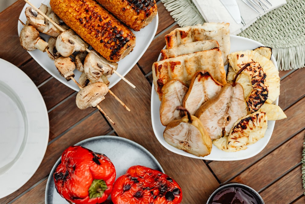 a wooden table topped with plates of food