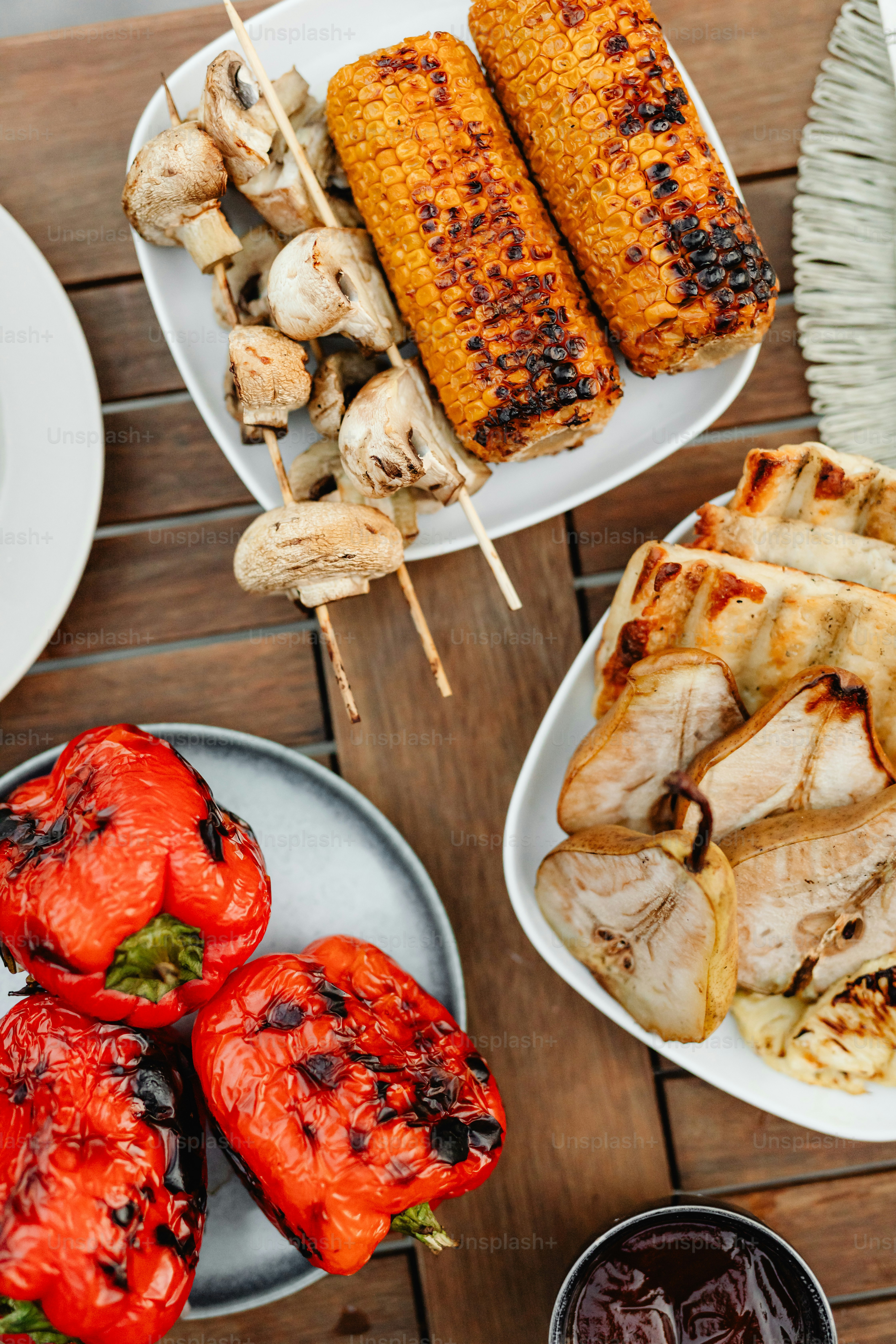 a wooden table topped with plates of food