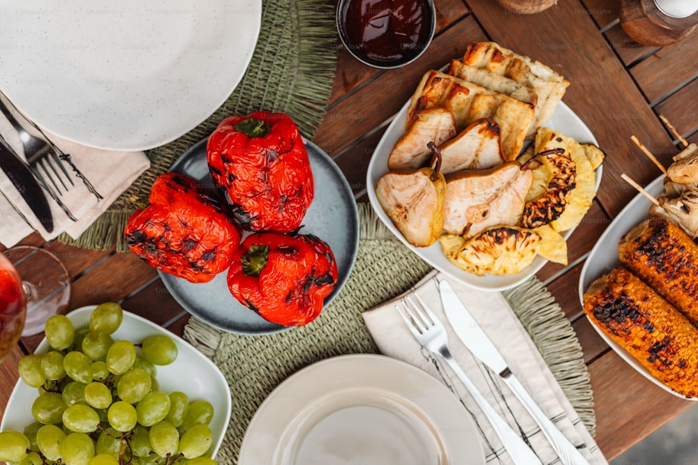 a table topped with plates and bowls of food