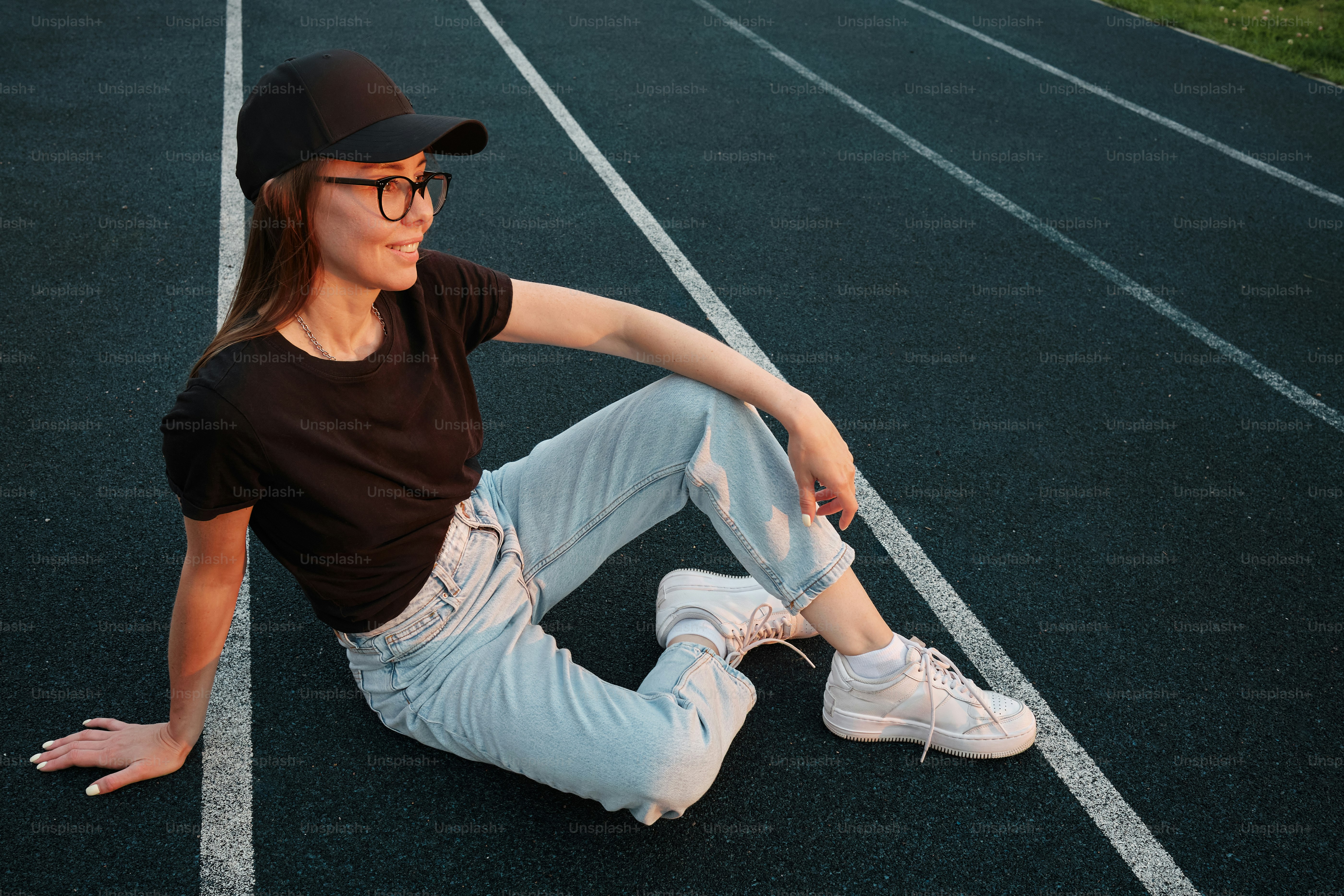 a woman sitting on the ground with her legs crossed