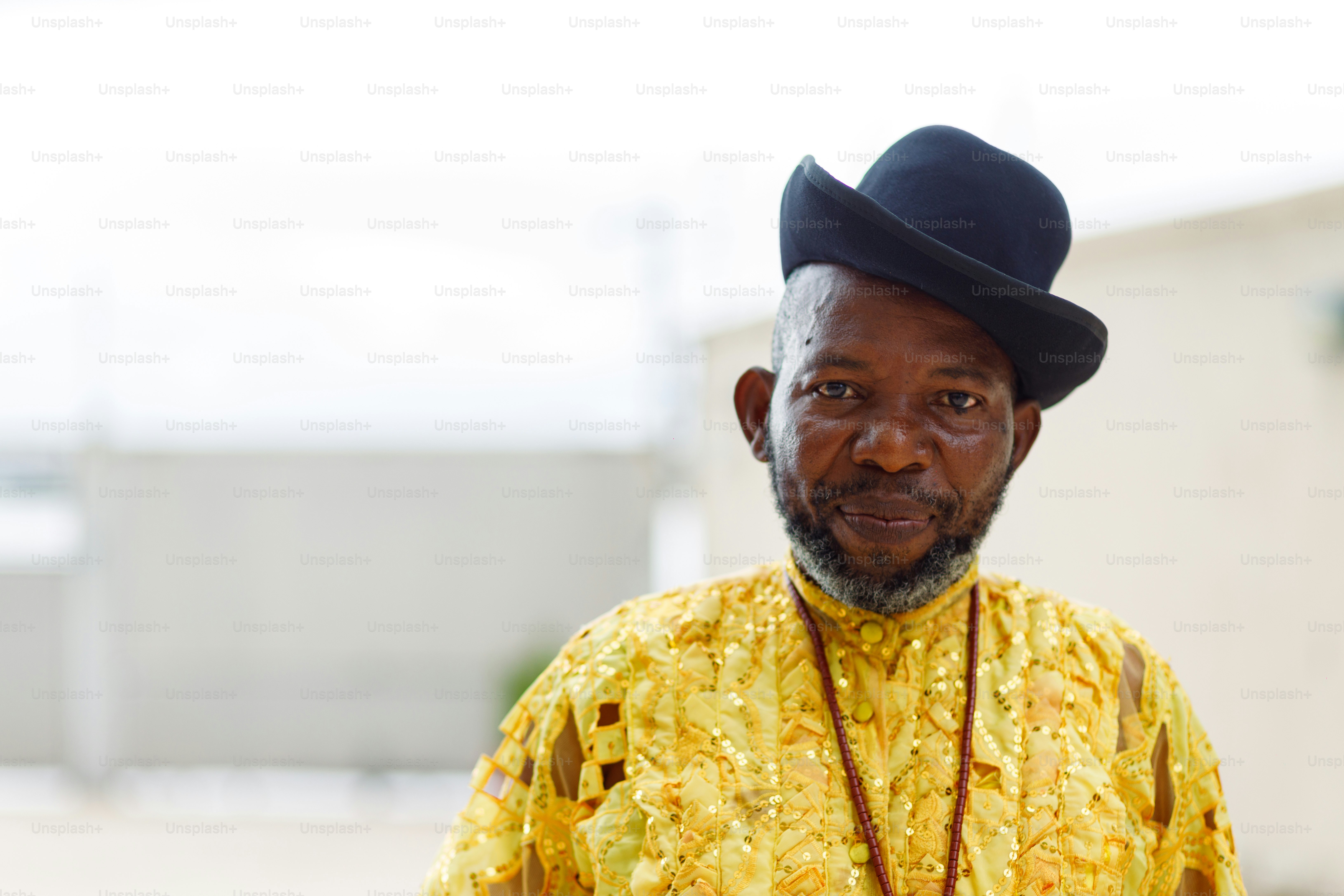 a man wearing a yellow shirt and a black hat