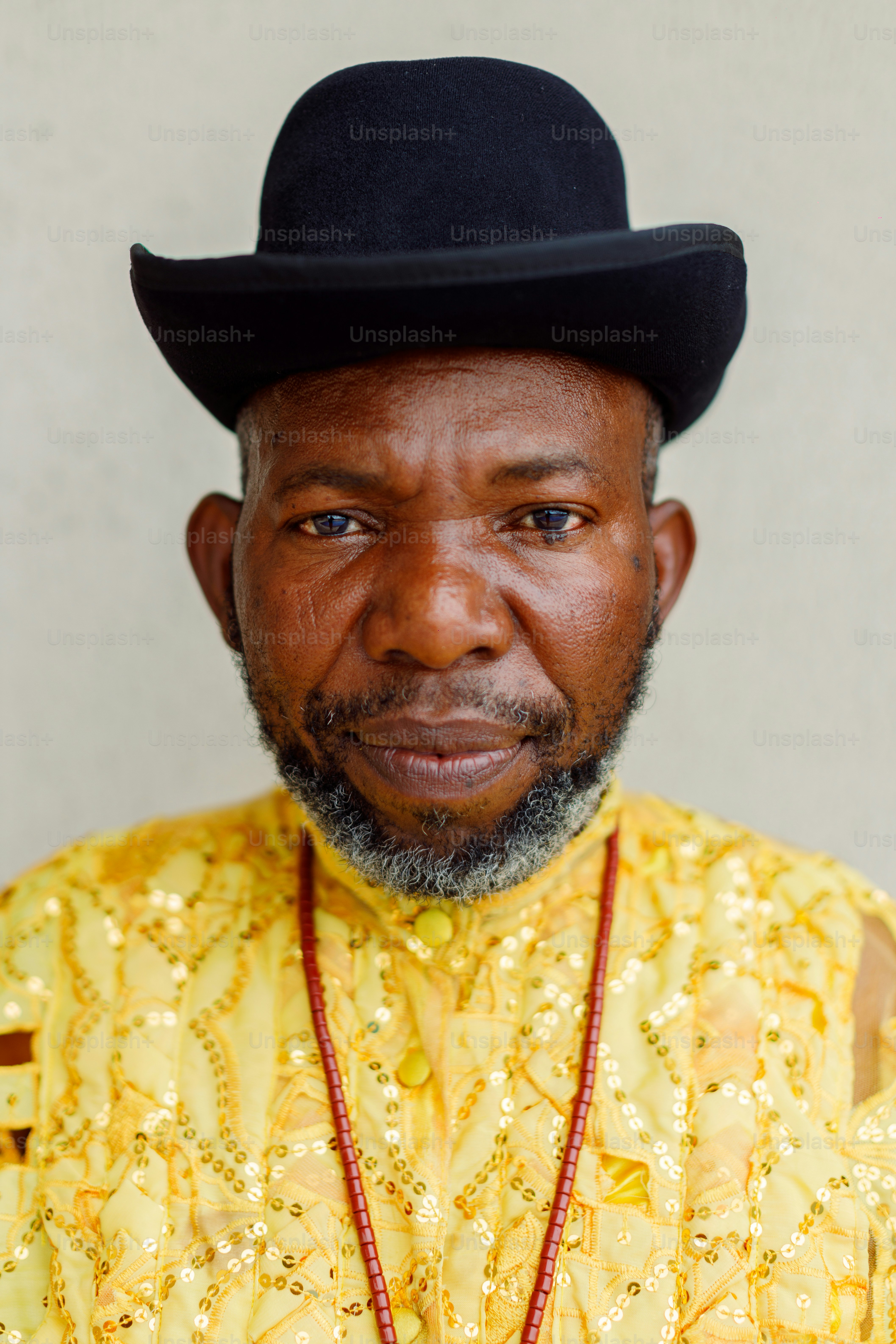 a man wearing a black hat and a yellow shirt