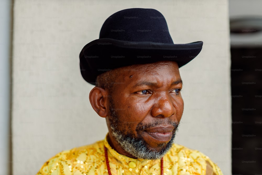 a man wearing a black hat and a yellow shirt