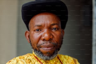 a man with a black hat and a yellow shirt