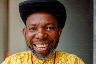 a man wearing a yellow shirt and a black hat