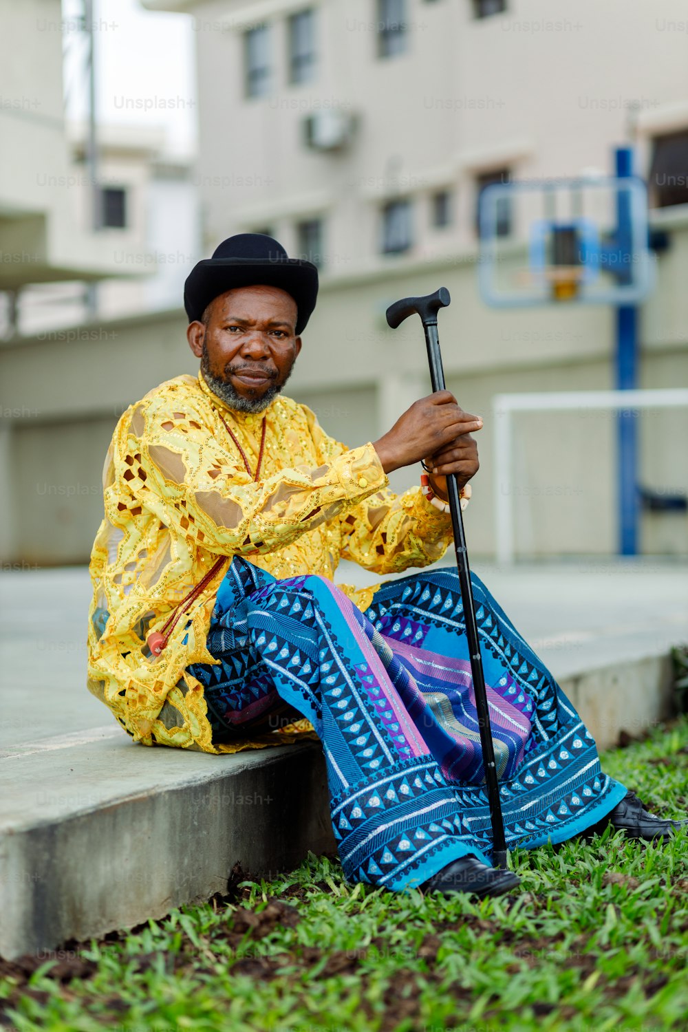 a man sitting on a step with a cane