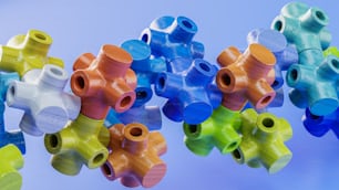 a bunch of colorful plastic pipes hanging from a ceiling
