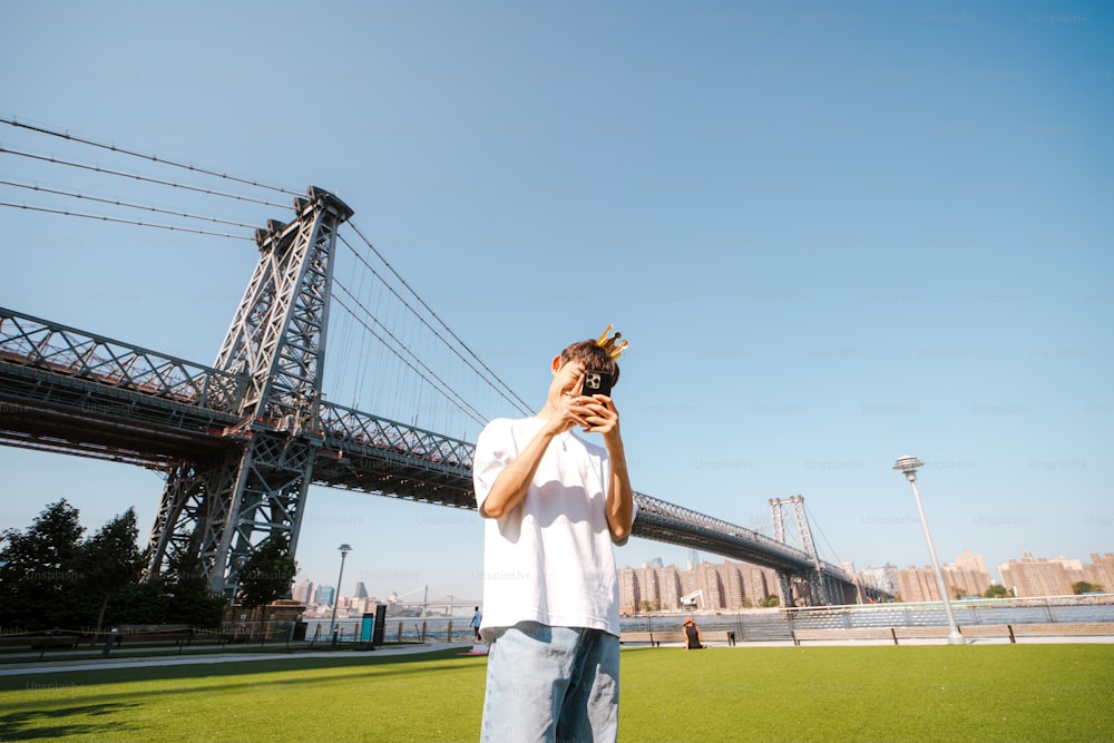 a man is taking a picture of a bridge