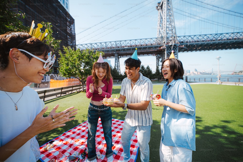 a group of people standing around a picnic table