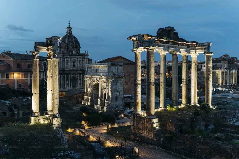 a large building with columns lit up at night