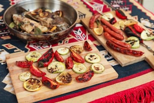 a table topped with a cutting board filled with sliced up vegetables