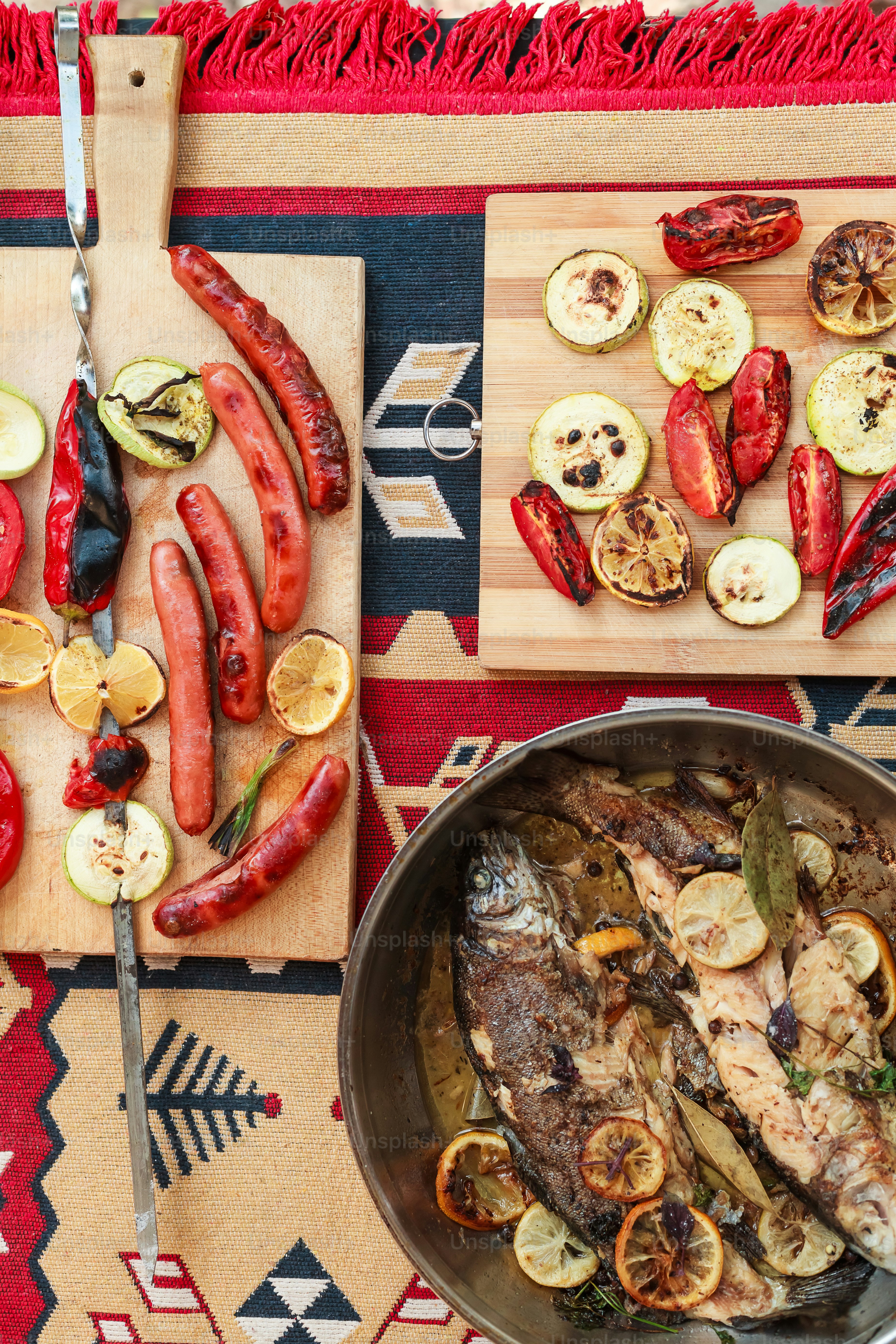 a table topped with a pan of food next to a cutting board