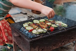 a person cooking food on top of a grill