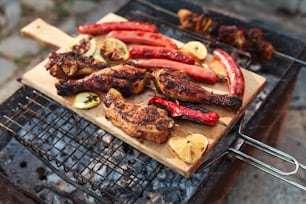 a bbq grill with meat and vegetables on it