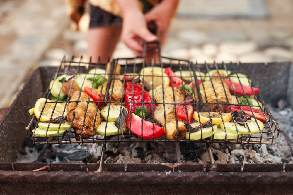 a person cooking food on top of a grill