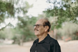 a man wearing glasses and a black shirt