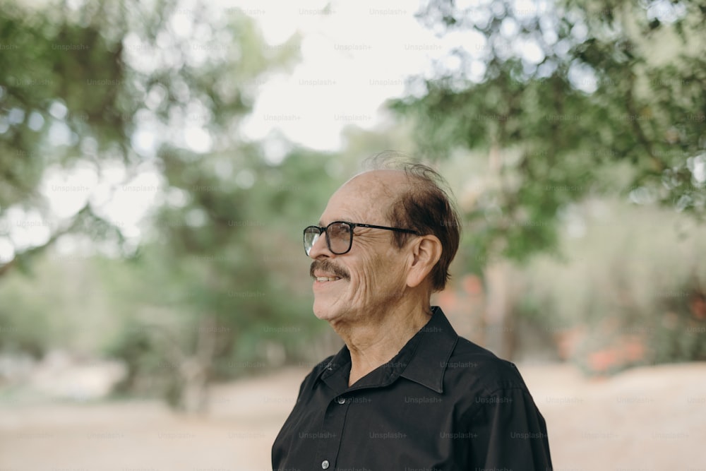 a man wearing glasses and a black shirt