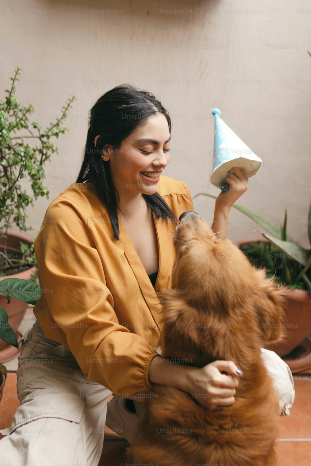 a woman is petting a dog with a cone on its head