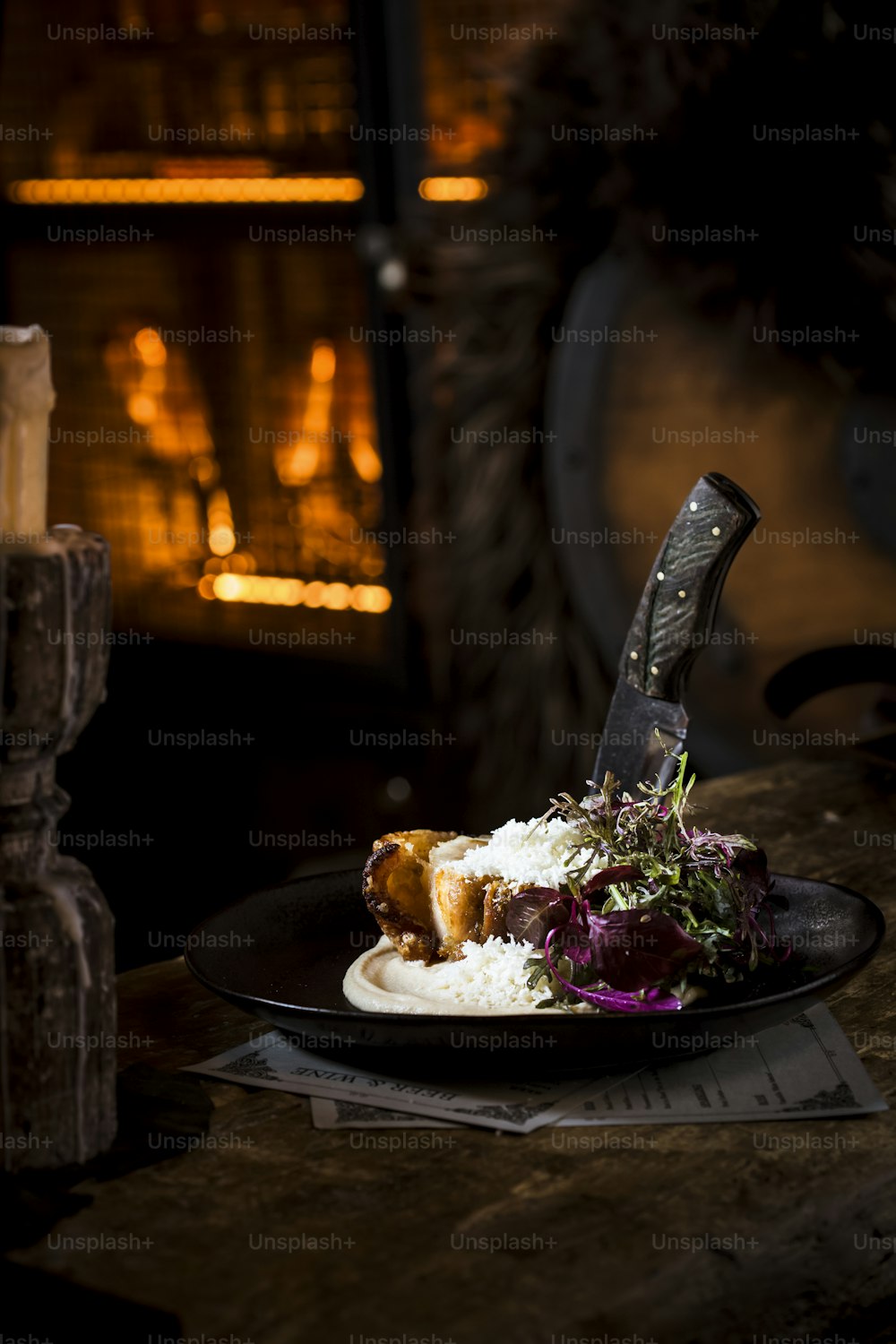 a plate of food with a knife sticking out of it