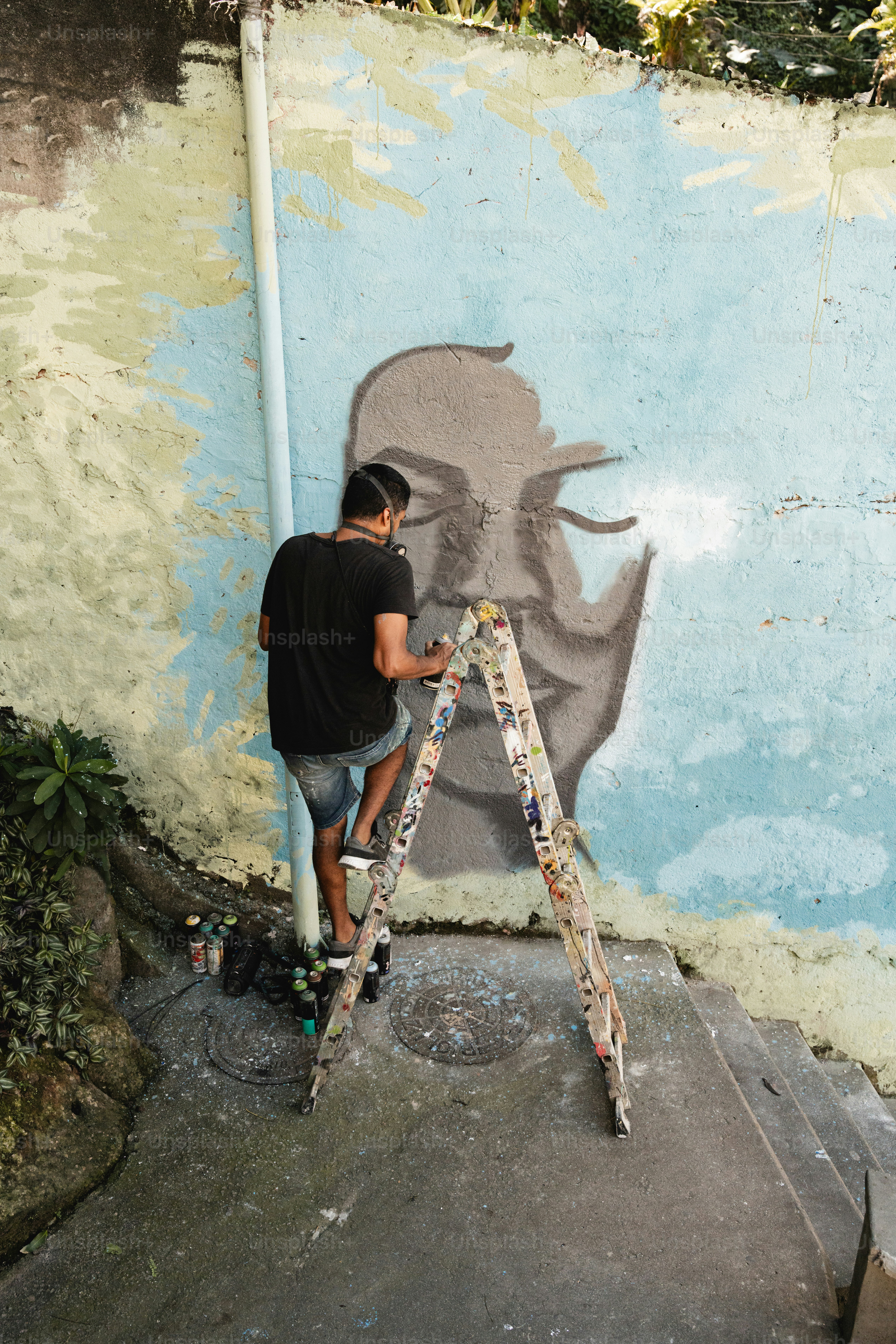 a man is painting a mural on a wall