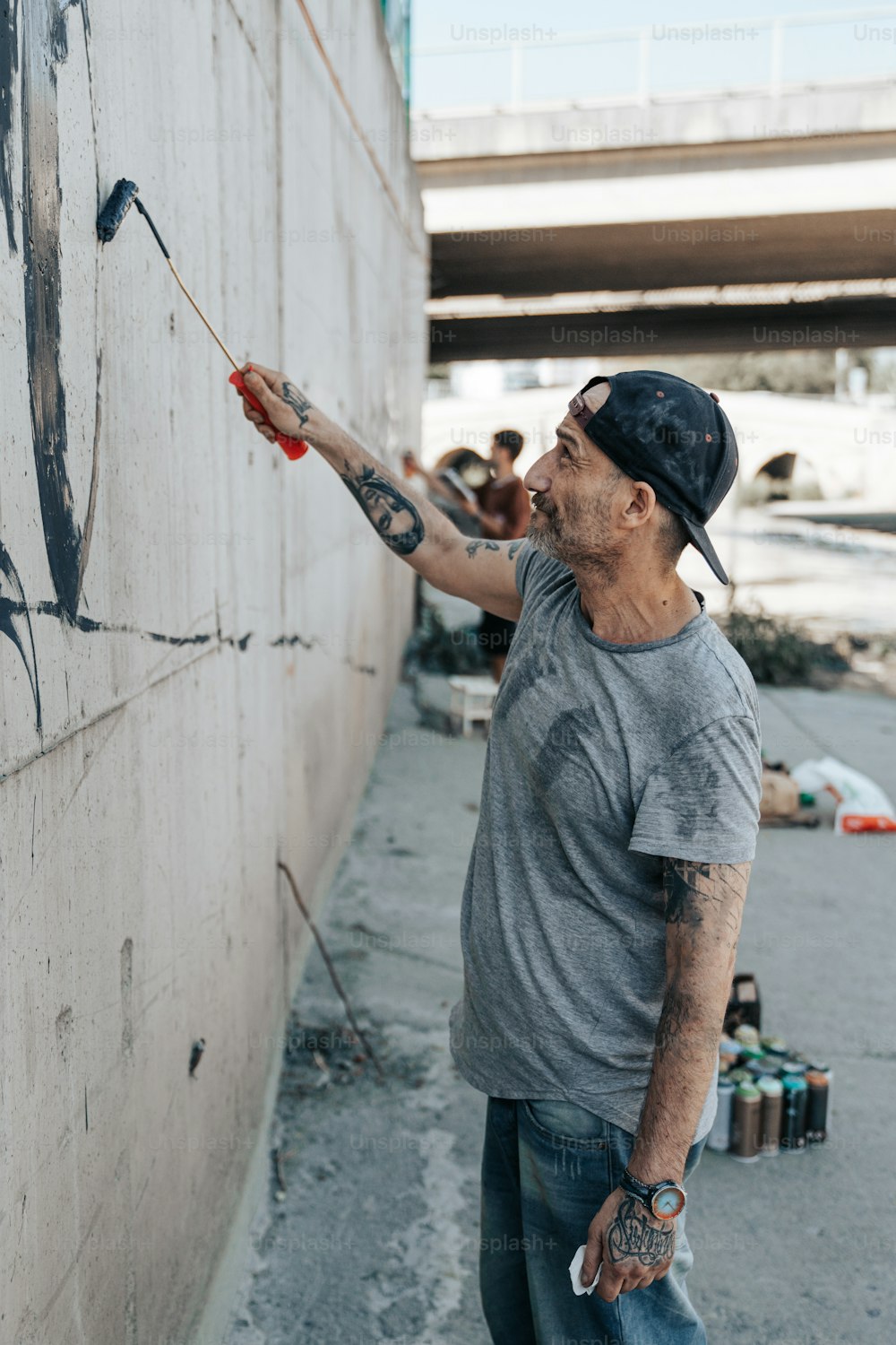 Ein Mann, der eine Wand mit einer Farbrolle streicht