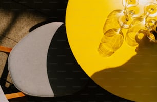 a close up of a yellow table and chairs