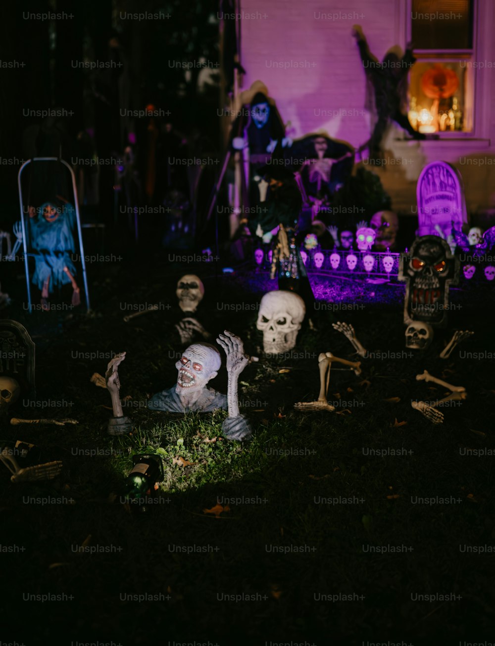 a group of skeletons in a yard at night