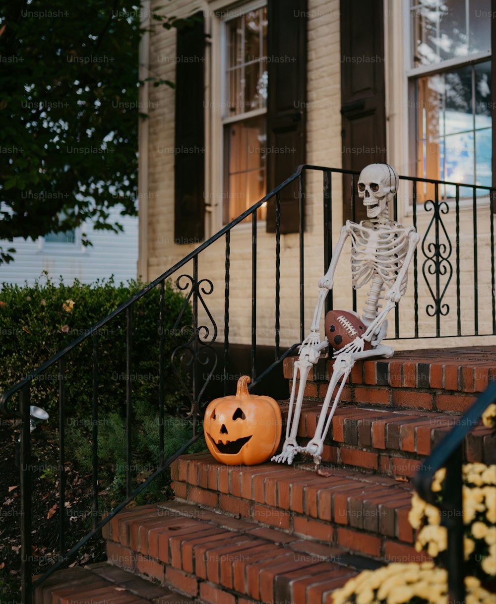 a skeleton sitting on the steps of a house