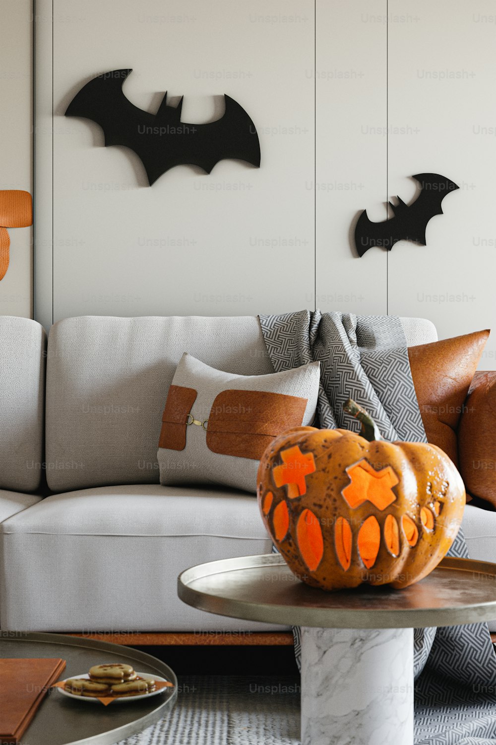 a living room with a couch and a table with a pumpkin on it