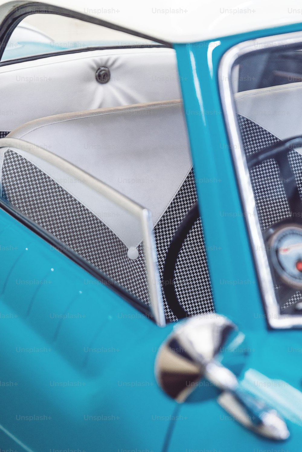 a close up of a blue car with a steering wheel