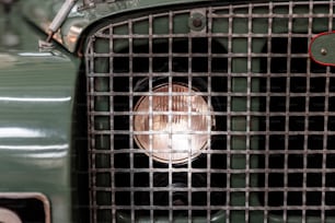 a close up of a grill on a green car