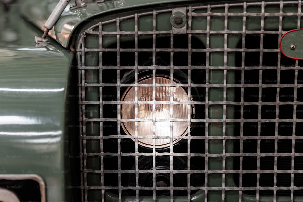 a close up of a grill on a green car