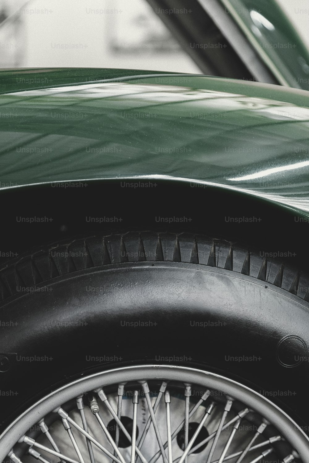 a close up of a tire on a green car