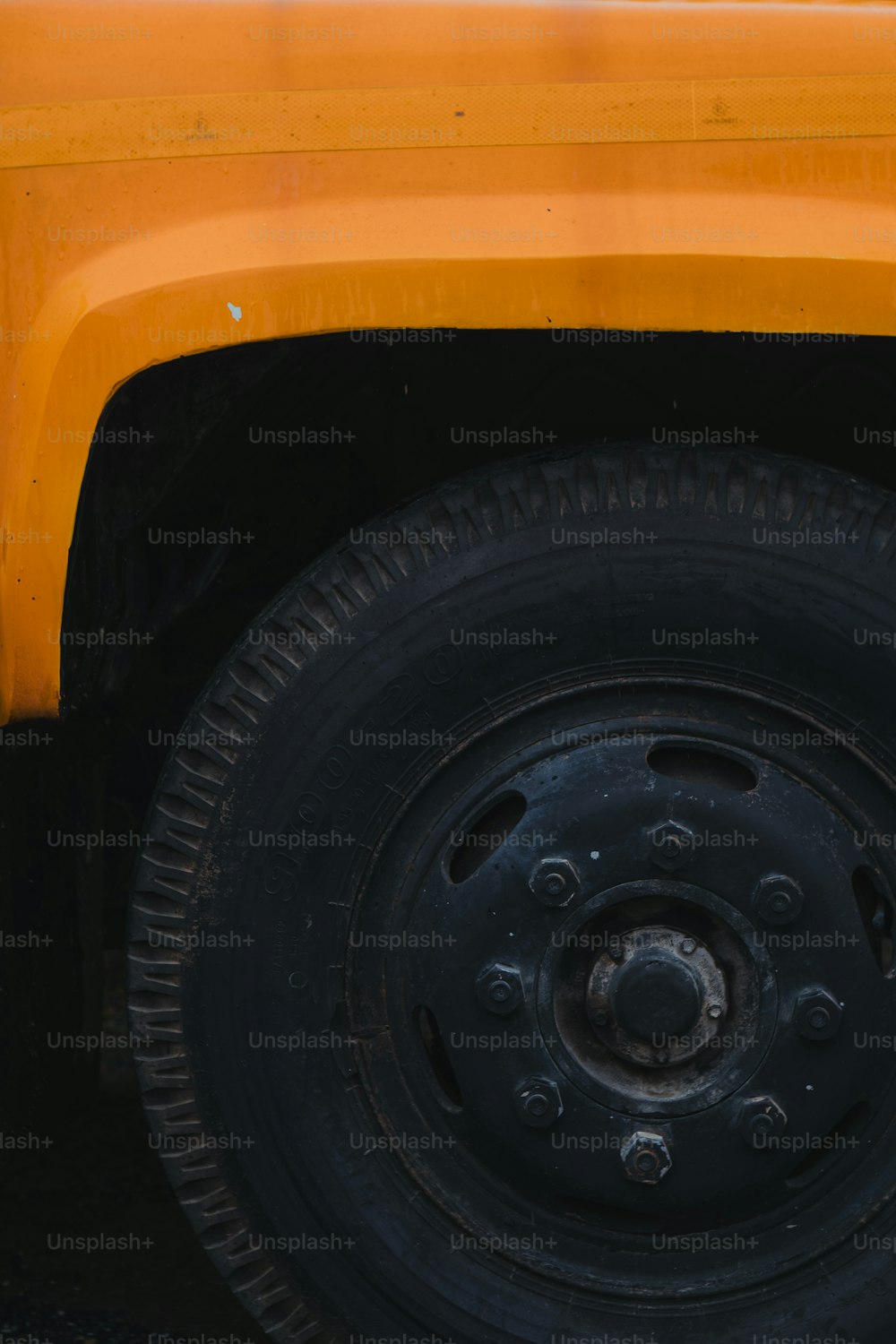 a close up of a yellow truck tire