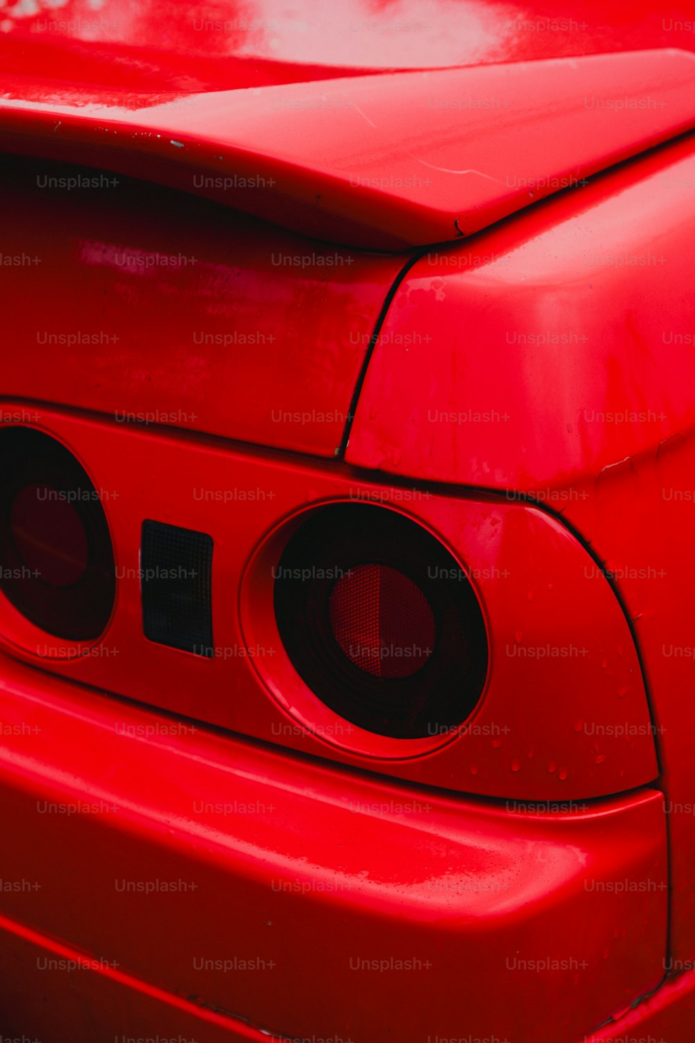 a close up of the rear end of a red car