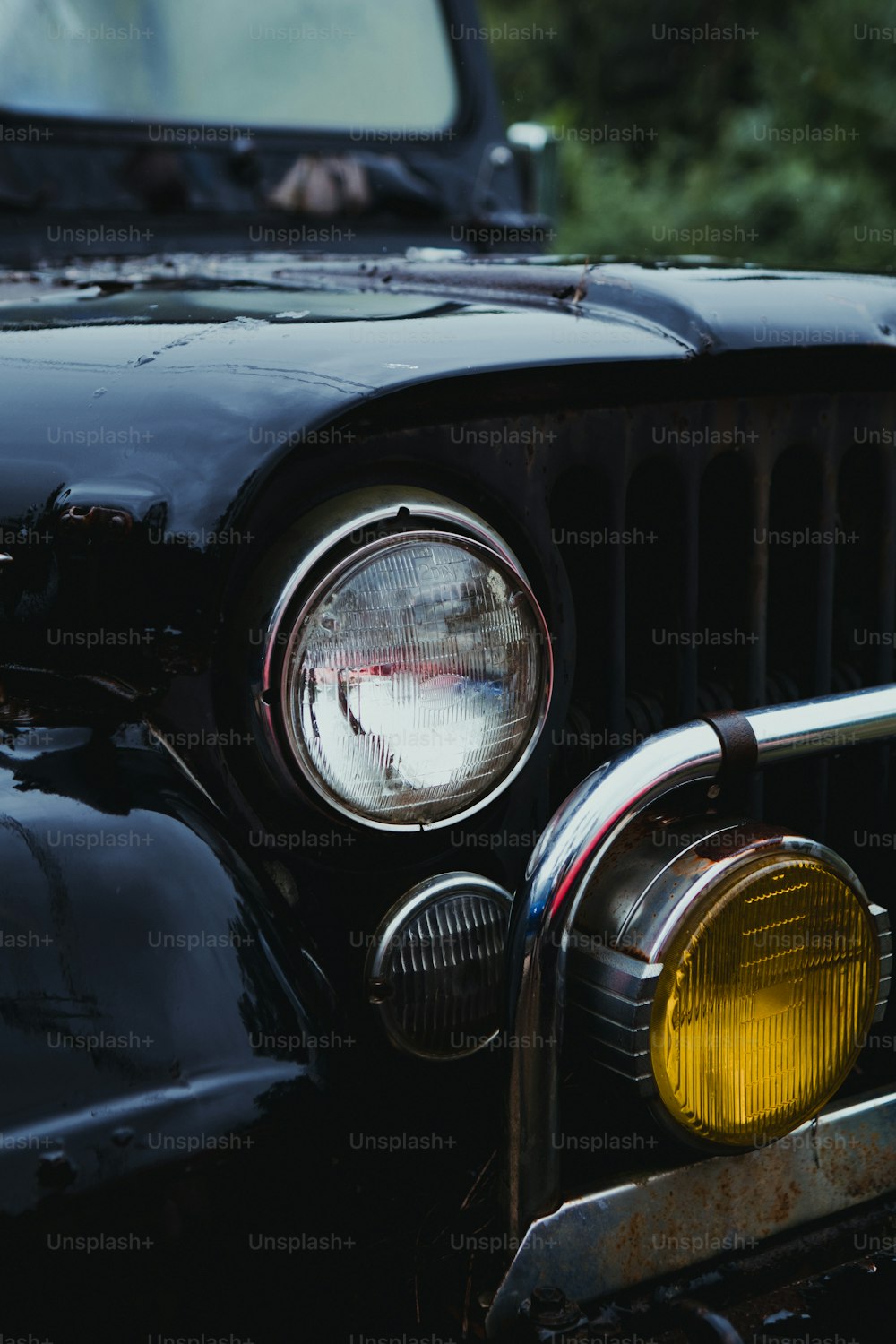 a close up of the front of a black jeep