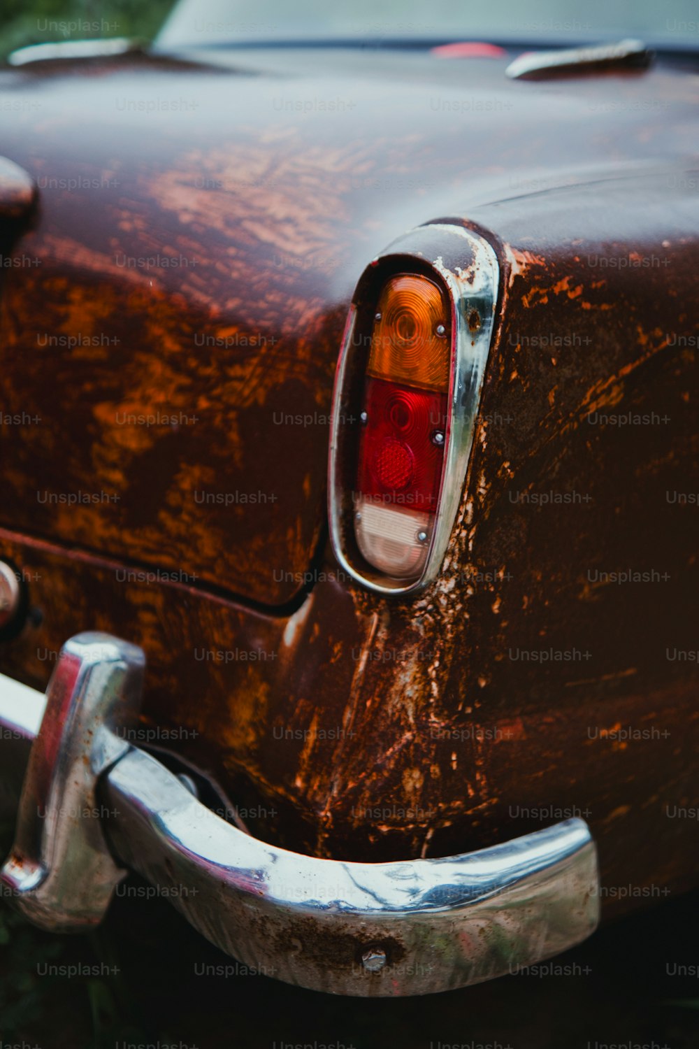 a close up of a rusted old car