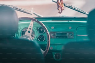 a green car with a steering wheel and dashboard