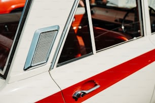 a close up of a red and white car door
