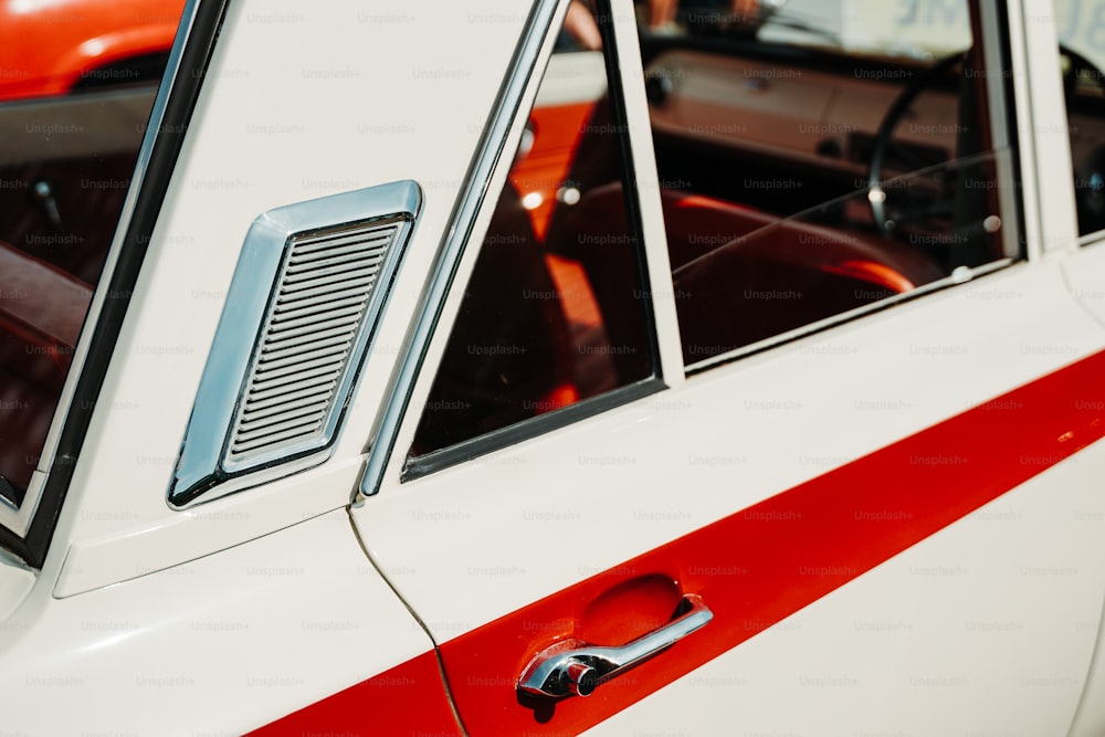 a close up of a red and white car door